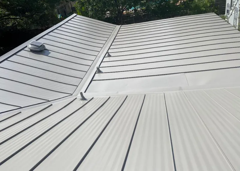 Solar attic fan installed on a metal roof for Roof Ventilation in Laketown